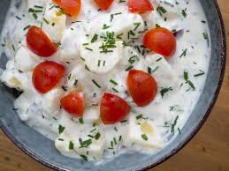 A Danish cold potato salad with cherry tomatoes