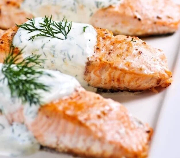 A plate of Norwegian Salmon with dill sauce