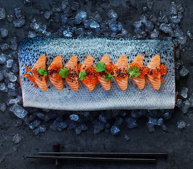 A serve of norwegian sashimi, on a plate made of literally fish